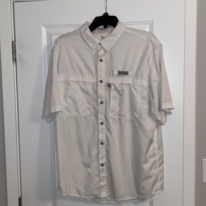 Size medium field and stream fishing shirt. Small ink stain on the left sleeve.